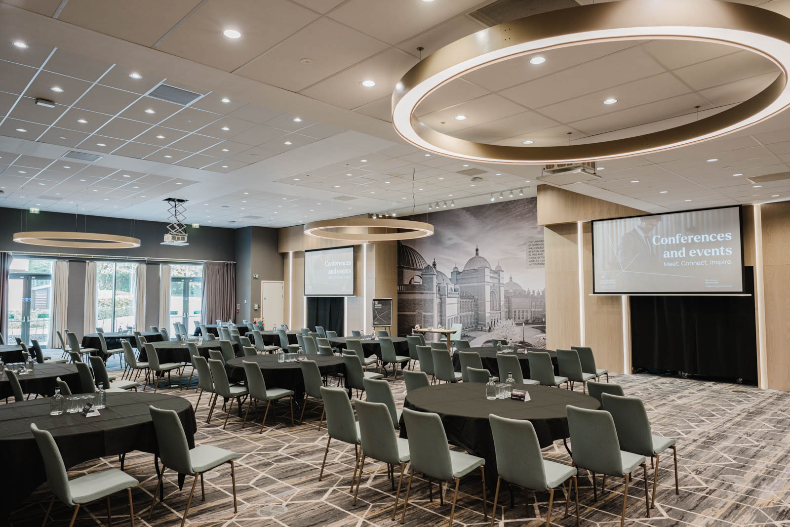 Edgbaston Park Hotel - interior view with chair and tables set out facing projector screens for a conference