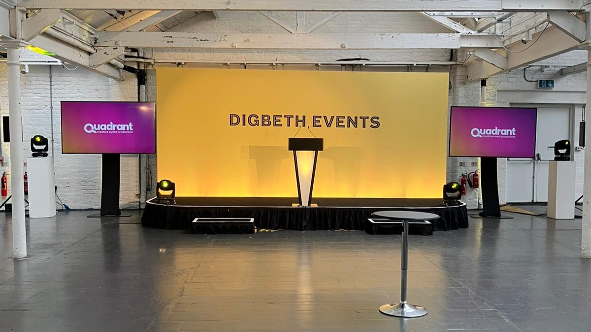 Stage and screens at Oval Digbeth, with Quadrant Events logo and branding and the words Digbeth Events on the backdrop
