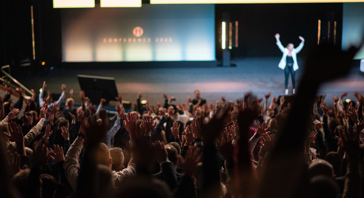 Host on stage at a conference, one of the live events run by Quadrant