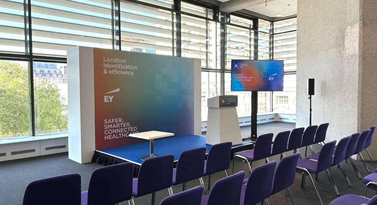 EY event stage and room laid out with AV hire equipment from Quadrant Events